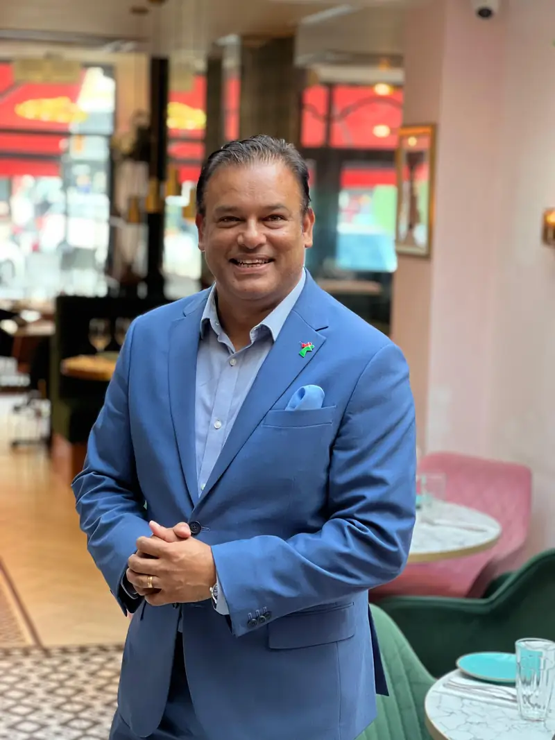 Sabbir Karim in a blue suit at one of his restaurants