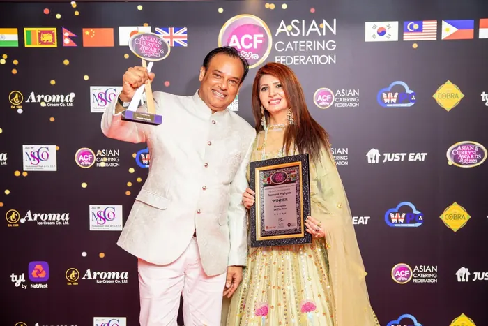 Sabbir Karim raising a trophy at an Asian Catering Federation awards night