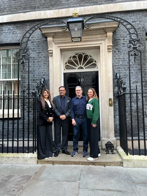 Sabbir Karim standing with three others outside 10 Downing Street