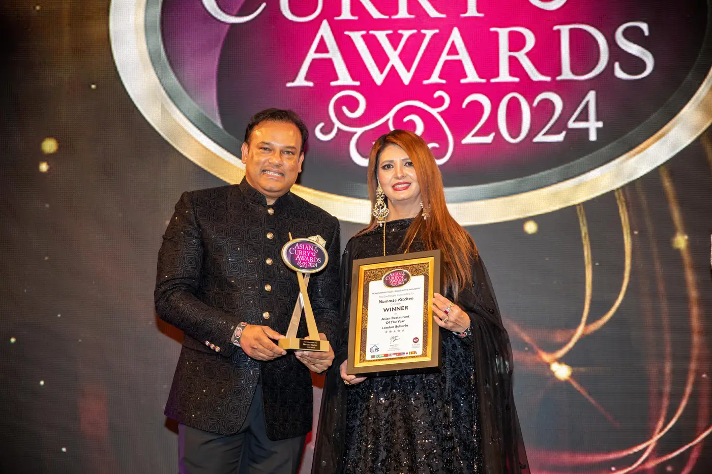 Sabbir Karim on stage with a trophy at the Asian Curry Awards 2024