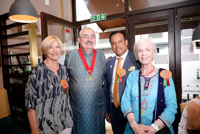Sabbir Karim with supporters of The Sreepur Village wearing rosettes